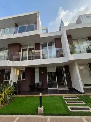 a large building with a lawn in front of it at Loft 39 Casa de playa in Coveñas
