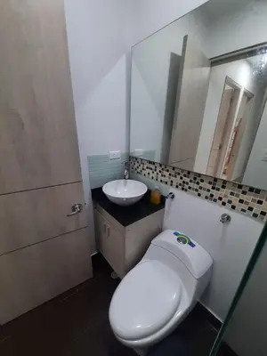 a bathroom with a white toilet and a sink at Loft 39 Casa de playa in Coveñas