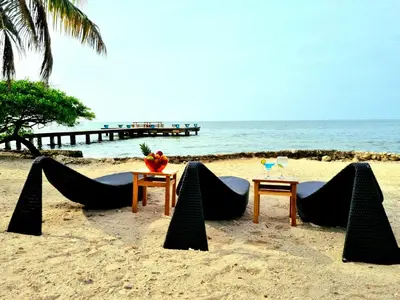 a table and chairs on a beach with the ocean at Casa Cordoba Baru in Baru
