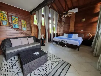 a bedroom with a bed and a couch in a room at Casa Cordoba Baru in Baru