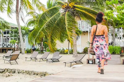 a woman walking down a wooden boardwalk in front of a resort at Casa Cordoba Baru in Baru