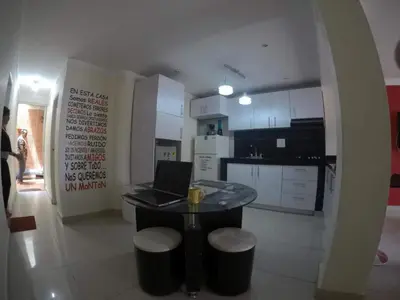 a kitchen with a table with a laptop on it at La casita de max y tim apt 201 in Cartagena de Indias