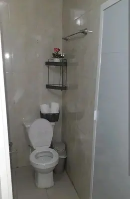 a bathroom with a white toilet and a shower at La casita de max y tim apt 202 in Cartagena de Indias