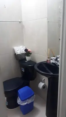 a bathroom with a black toilet and a sink at La casita de max y tim apt 202 in Cartagena de Indias