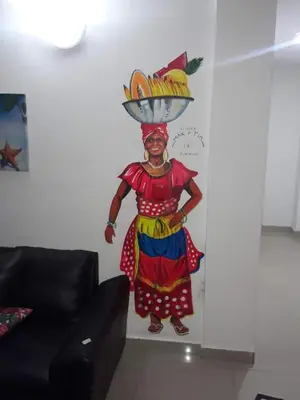 a painting of a woman with a bowl on her head at La casita de max y tim apt 202 in Cartagena de Indias