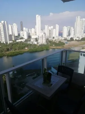 a balcony with a table and a view of a city at Cartagena de Indias, Mar, historia y diversión ! in Cartagena de Indias