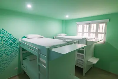 a room with two bunk beds and a window at San Felicin Hostel in Cartagena de Indias