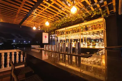 a bar with a lot of bottles and glasses at San Felicin Hostel in Cartagena de Indias