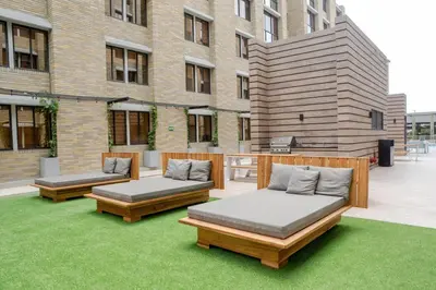 two beds on a lawn in front of a building at LivinnX Barranquilla in Barranquilla