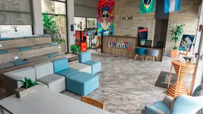 a lobby of a restaurant with tables and chairs at LivinnX Barranquilla in Barranquilla