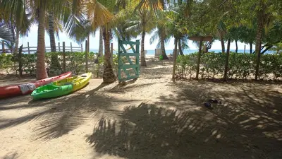 a playground on the beach with palm trees at Cabaña sostenible Isla Fuerte in Isla Fuerte