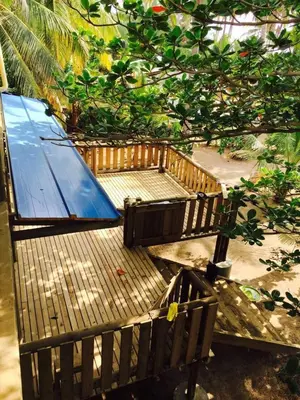 a group of benches sitting under a tree at Cabaña sostenible Isla Fuerte in Isla Fuerte