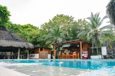 a resort with a swimming pool and a bar at Hotel Isla del Sol in Isla Grande