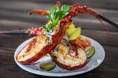 a plate of food with lobster on a table at Hotel Isla del Sol in Isla Grande
