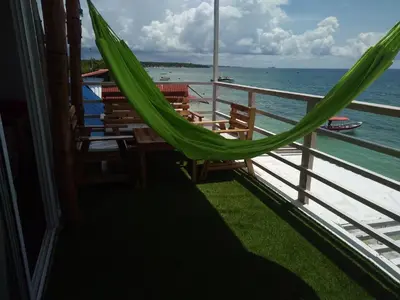 a balcony with a hammock on a cruise ship at posada donde Uriel Playa tranquila in Baru