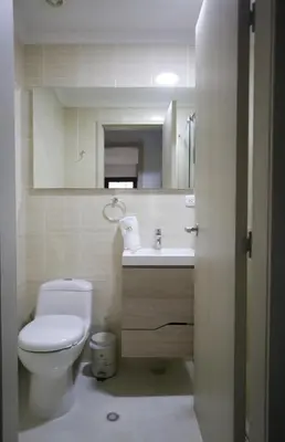 a bathroom with a toilet and a sink and a mirror at Apartamento Edificio Portofino 701 in Cartagena de Indias