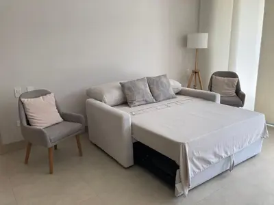 a bed with a couch and a chair in a room at Serena del Mar, Morros IO in Cartagena de Indias
