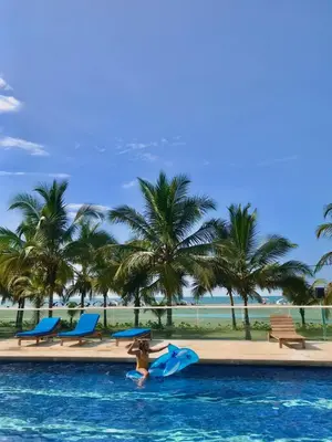 a woman in the water in a pool at a resort at Hermoso apartamento en la playa in Cartagena de Indias