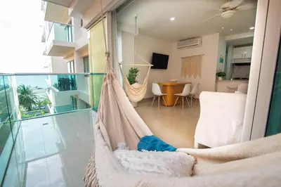 a hammock in a room with a living room at Hermoso apartamento en la playa in Cartagena de Indias