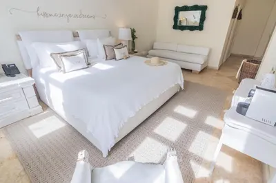 a bedroom with a large white bed and a couch at Casa Diluca Cartagena Hotel Boutique in Cartagena de Indias