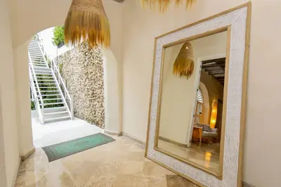a large mirror in a room with a hallway at Casa Diluca Cartagena Hotel Boutique in Cartagena de Indias