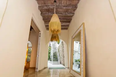 a hallway with a ceiling and a mirror and a chandelier at Casa Diluca Cartagena Hotel Boutique in Cartagena de Indias