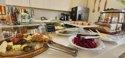 a buffet line with different types of food on a counter at Casa Diluca Cartagena Hotel Boutique in Cartagena de Indias