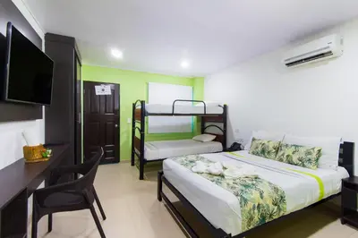 a bedroom with a bed and a desk and a bunk bed at Hotel Marina Suites By GEH Suites in Cartagena de Indias