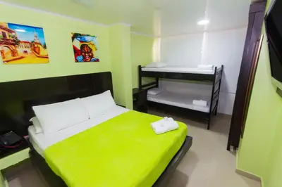 a small room with a bed and a small bunk bed at Hotel Marina Suites By GEH Suites in Cartagena de Indias