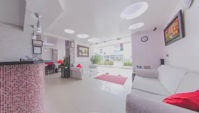a living room with white furniture and a red at Hotel Marina Suites By GEH Suites in Cartagena de Indias