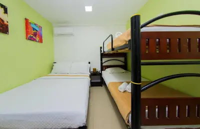 two bunk beds in a room with green walls at Hotel Marina Suites By GEH Suites in Cartagena de Indias