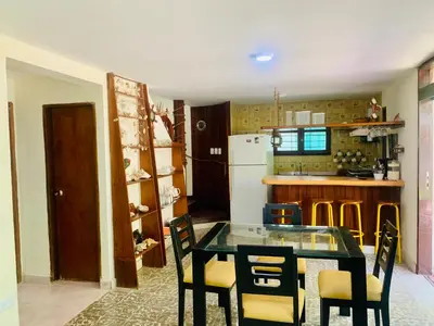 a kitchen with a table and chairs in a room at Santa Marta Bello Horizonte - Cabañas Don Rafa in Santa Marta