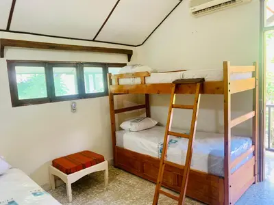 a bedroom with two bunk beds and a window at Santa Marta Bello Horizonte - Cabañas Don Rafa in Santa Marta