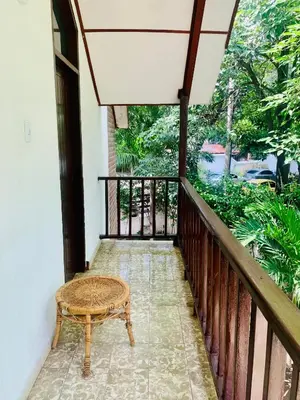 a balcony with a bench and a table at Santa Marta Bello Horizonte - Cabañas Don Rafa in Santa Marta