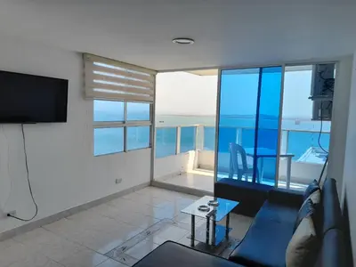 a living room with a view of the ocean at Apartamento en Cartagena Edificio El conquistador Sector el Laguito - By Corfeinco in Cartagena de Indias