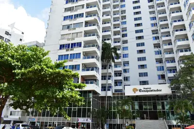 a tall white apartment building with a sign on it at Apartamento en Cartagena Edificio El conquistador Sector el Laguito - By Corfeinco in Cartagena de Indias
