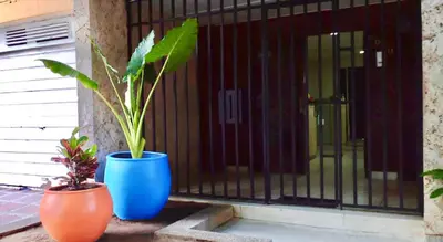 two blue vases sitting next to a gate with a plant at La Quinta Bacana La Campiña in Barranquilla