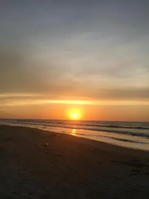 a sunset on a beach with the ocean at Cabaña La Blanquita in San Bernardo del Viento