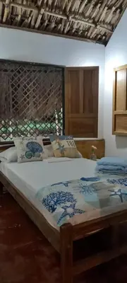 a bedroom with a large bed in a room at La Coralina azul in San Bernardo del Viento
