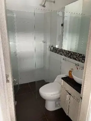 a white bathroom with a toilet and a sink at Casa de Playa frente al mar. in Coveñas