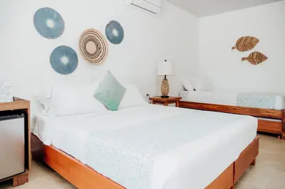 a bedroom with two beds and a wall with planets at Hotel Carey Beach Baru in Baru