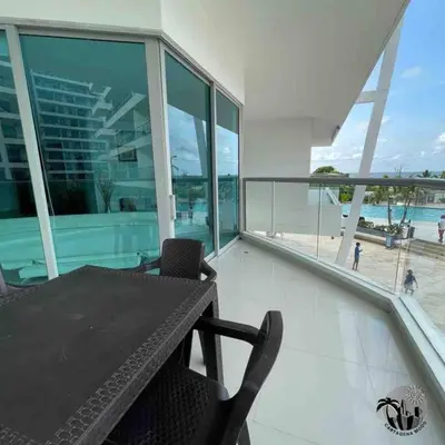 a balcony with a table and chairs and a view of the ocean at Cartagena apartamento in Cartagena de Indias