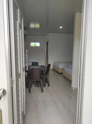 a room with a table and chairs and a bed at Apartamentos Villa Leonor in Coveñas
