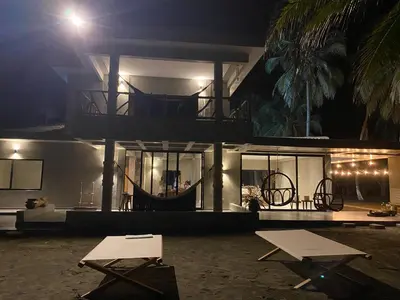 a house at night with a table in front of it at Sea La Vie in San Bernardo del Viento