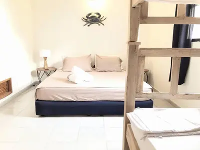 a bedroom with a bed with a spider on the wall at Amplio dúplex con playa y mall a una cuadra in Santa Marta