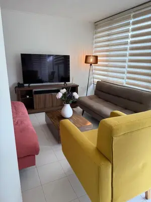 a living room with a couch and a tv at A metros de las playas de Bello Horizonte y de Centro Comercial Zazue in Santa Marta