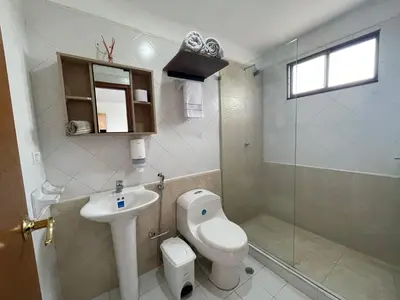 a bathroom with a toilet and a sink and a shower at A metros de las playas de Bello Horizonte y de Centro Comercial Zazue in Santa Marta