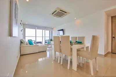 a dining room and living room with a table and chairs at Beachfront Paradise with Outstanding Sunset Views in Cartagena de Indias