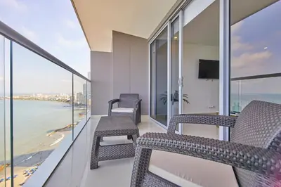 a balcony with chairs and a view of the ocean at Beachfront Paradise with Outstanding Sunset Views in Cartagena de Indias