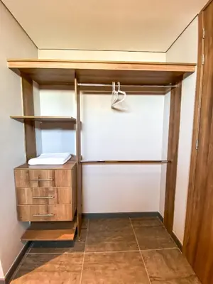 a walk in closet with wooden shelves at Gz Tower Apartamento Barranquilla in Barranquilla